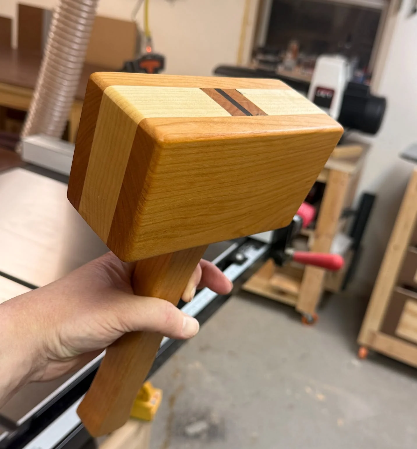 Handcrafted wooden mallet with contrasting woods and small accent stripes